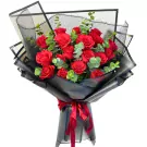 A bouquet of 18 red roses with eucalyptus leaves, wrapped in black paper and tied with a red ribbon.