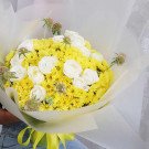 Yellow daisies and white roses bouquet with scabiosa and yellow ribbon.