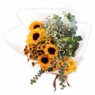 Bouquet of sunflowers, yellow daisies, and eucalyptus leaves.