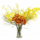 Yellow orchids and orange chrysanthemums in a glass vase.