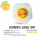 Sunny Side Up bath bomb shaped like a fried egg with a smiley face.