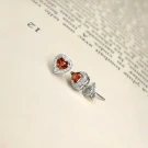 Crimson heart garnet and diamond halo stud earrings set in silver.