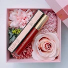 Gucci lipstick in a gift box with pink flowers.