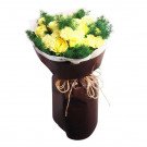 Yellow roses and carnations with green foliage, wrapped in brown paper and tied with twine.