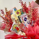 Bouquet with Monopoly, Lotteria, Horse Racing, O An Quan, and playing cards, decorated with red berries and gold accents.