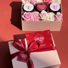 Pink gift box with flowers, three candles, and a "Love You 3000" card.