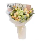 Bouquet of peach roses, hydrangeas, and carnations in newspaper wrap.