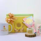 Gift box with sunflower, mug, and lemongrass candle for Women's Day.