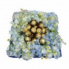 Box of blue hydrangeas, daisy flowers, and Ferrero Rocher chocolates.