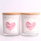 Two white candles with bamboo lids, featuring pink heart labels that say "You make my heart to be in love".