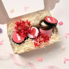 Gift box with candle and decorative flowers, featuring "I", heart, and "U" symbols.
