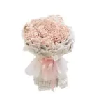 Pink baby's breath bouquet wrapped in textured fabric with a pink ribbon.