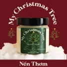 Candle with "My Christmas Tree" label, featuring a pine tree design, surrounded by faux snow.