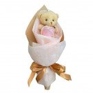 Cute teddy bear and pink rose in a gift bouquet, tied with a gold ribbon.