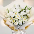 A bouquet of white tulips, elegantly wrapped.