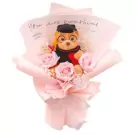 Graduation teddy bear bouquet with pink roses and baby's breath, wrapped in pink paper.