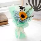 Sunflower bouquet with baby's breath and a graduation cap-wearing teddy bear.