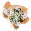 Bouquet of blue hydrangeas, yellow daisies, and baby's breath wrapped in brown kraft paper.