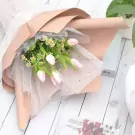 Pink tulips and tiny white flowers in a blush pink and sheer starry wrap.