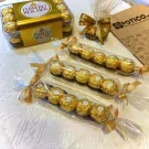 Ferrero Rocher chocolates in a gift box and individually wrapped in gold foil.
