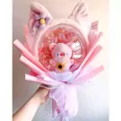 Pink pig balloon bouquet with cat ears and flower accent.