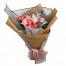 Pink roses in a kraft paper bouquet with "Gorgeous You" text, tied with a ribbon.