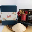 Gift box with scented candles, diffuser, and conical hat for Tet (Vietnamese New Year).
