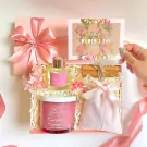 Pink gift box with La Rose candle, diffuser, LOVE bag, cinnamon sticks, and Women's Day card.