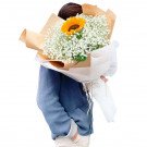 Person holding a bouquet of sunflowers and baby's breath, wrapped in brown and white paper.