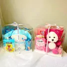 Two gift boxes with plush toys and snacks.