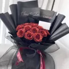 Sparkling ruby bouquet with black wrapping and ribbons.