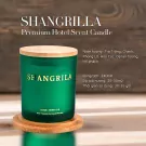 Green Shangrila scented candle with wooden lid on a wooden coaster, detailed description and product information.