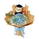 Graduation teddy bear with blue hydrangeas and baby's breath in brown paper wrapping.