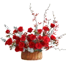 Basket of red roses with decorative branches and leaves.