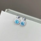 Starlight blue topaz stud earrings with small silver stars.