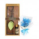Aromatic stone oil set with leaf diffuser, essential oil, and dried blue flowers.