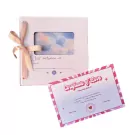 A pink ribbon-tied "Just Between Us" notebook and a "Certificate of Love" card.