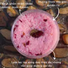 Pink rose-infused bath salts in a clear jar with text highlighting natural ingredients and benefits.