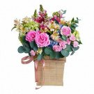 Wooden box of pink roses, hydrangeas, carnations, snapdragons, and eucalyptus.