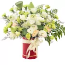 Red box bouquet with white lotus, green and white carnations, and lisianthus.