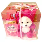 Pink gift box with a teddy bear and assorted sweets.