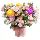 Pink box of mixed flowers including pink daisies, yellow chrysanthemums, and pink roses.