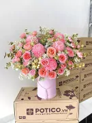 Pink peony and rose flower box with gold accents and tassel on pink hatbox.