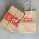 Gift box and bag with "Happy Gift Box" labels on a gray surface.