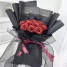 Sparkling ruby bouquet with black wrapping and Chanel ribbon.