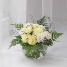 Yellow and white carnations with ferns in a clear glass bowl.