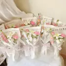 Crocheted flower bouquets wrapped in clear cellophane with pink bows and inscribed messages.