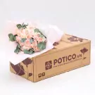 A bouquet of pink roses and eucalyptus in a POTICO.VN flower box.
