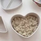 Heart-shaped bento box filled with brown rice