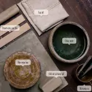 Pottery workshop supplies: clay, rolling pin, water bowl, spinning wheel, and tools.